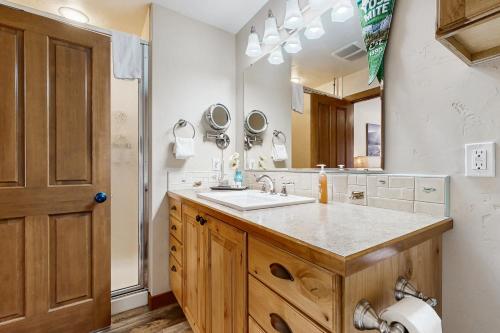 a bathroom with a sink and a large mirror at Rivers Edge Retreat in McCall