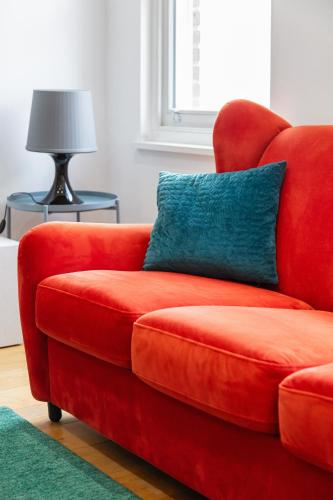 a red couch with a blue pillow in a living room at 2 bed 2 bath Penthouse,terrace,London Eye,sleeps 6 in London