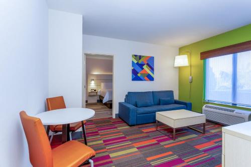 a living room with a couch and a table at Holiday Inn Express-International Drive by IHG in Orlando