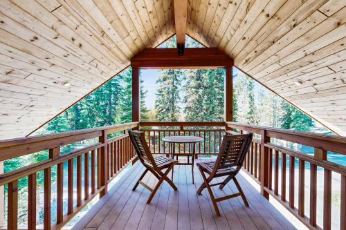 a room with two chairs and a table on a balcony at McAbu House in McCall