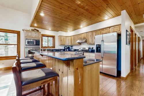 a kitchen with wooden cabinets and a stainless steel refrigerator at McAbu House in McCall