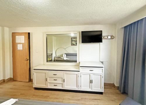 a white dresser with a mirror in a room at Hotel Faro in Mexico City