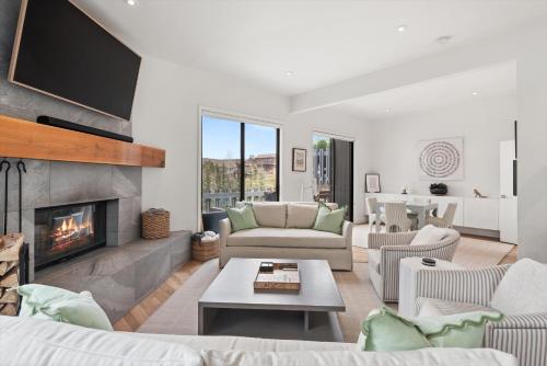 a living room with couches and a fireplace at Meadow Mountain Vista Multi-level 3br W Hot Tub in Snowmass Village