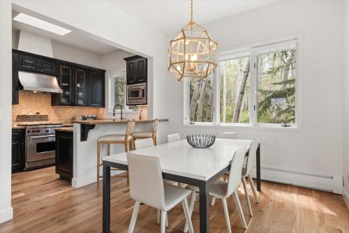 a kitchen with a dining room table and chairs at Meadow Mountain Vista Multi-level 3br W Hot Tub in Snowmass Village