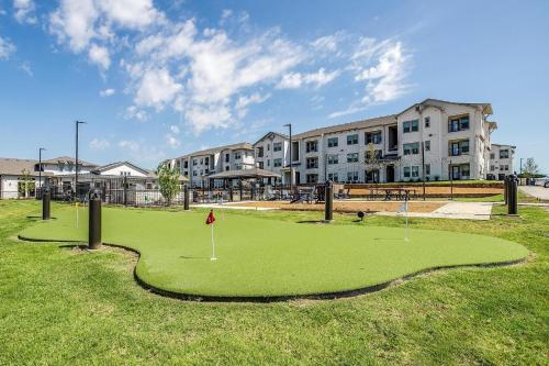 a golf course in front of a building at Chisholm Trace 1235 I Spacious 1 Bed 1 Bath in Cleburne
