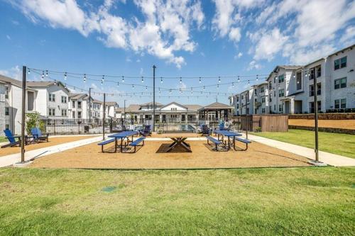 a group of picnic tables and chairs in a park at Chisholm Trace 1235 I Spacious 1 Bed 1 Bath in Cleburne
