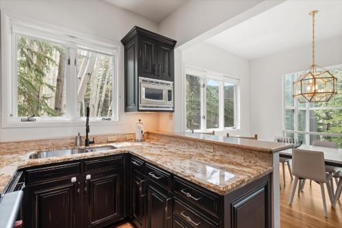 a kitchen with a sink and a counter top at Meadow Mountain Vista Multi-level 3br W Hot Tub in Snowmass Village