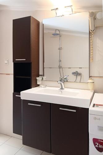 a kitchen with a sink and a mirror at Metaxenia's apartment 301 in Thessaloniki