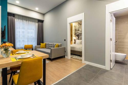 a living room with a dining table and a couch at Days Inn & Suites by Wyndham Esenyurt in Istanbul