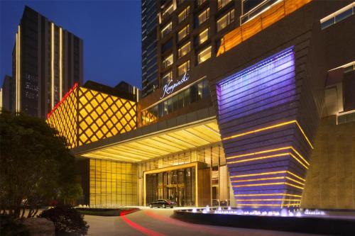 a building with a lit up facade at night at Kempinski Hotel Fuzhou in Fuzhou