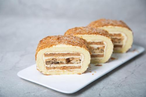 three sandwiches on a white plate on a table at Kempinski Hotel Fuzhou in Fuzhou