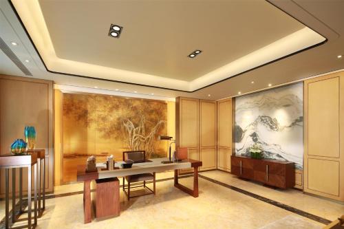 an office with a desk and a large painting on the wall at Kempinski Hotel Fuzhou in Fuzhou