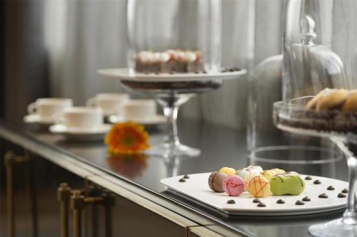 a table with a plate of pastries on it at Kempinski Hotel Fuzhou in Fuzhou