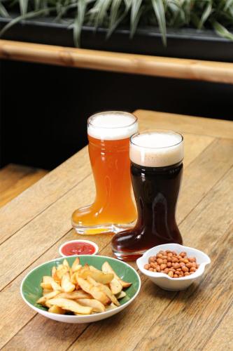 two glasses of beer and a plate of fries and beans at Kempinski Hotel Fuzhou in Fuzhou
