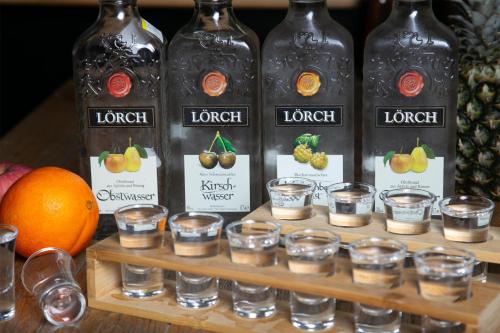a display of liquor bottles and glasses on a shelf at Kempinski Hotel Fuzhou in Fuzhou