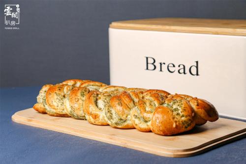 a bunch of bread on a cutting board next to a box at Kempinski Hotel Fuzhou in Fuzhou