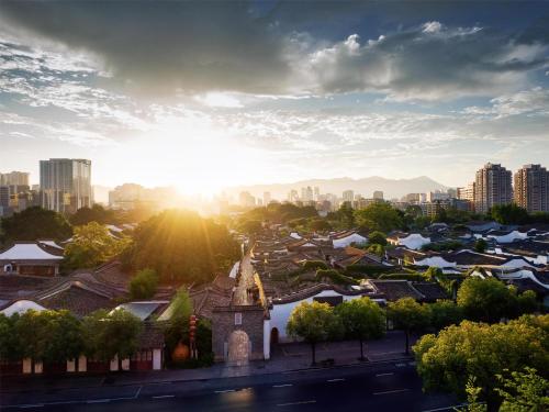 a view of a city with the sun setting at Kempinski Hotel Fuzhou in Fuzhou