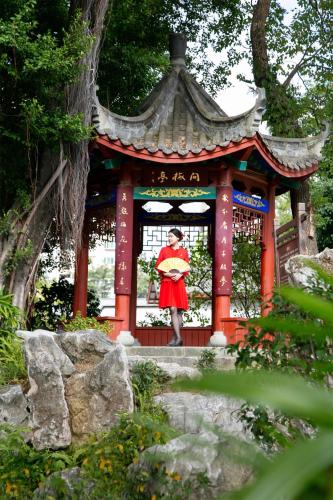 a woman standing in front of a pagoda at Kempinski Hotel Fuzhou in Fuzhou