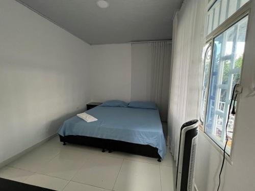 a small bedroom with a bed and a window at Finca Hotel Villa el Ocaso Huila in Rivera