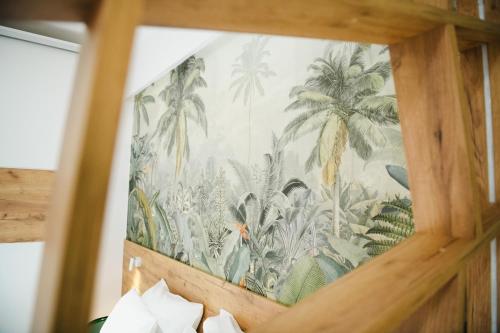 a tapestry of palm trees on a wall at Alexandros in Giannitsa