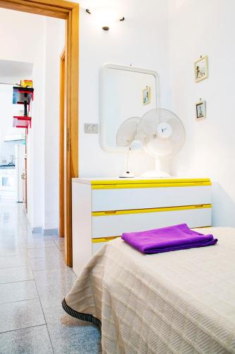 a bedroom with a bed with a lamp and a mirror at Manzoni Apartment in Le Castella
