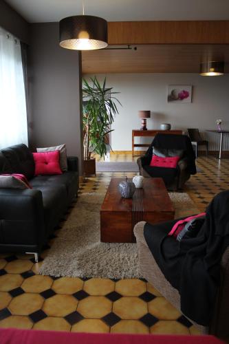 a living room with two couches and a table at Hôtel Restaurant le Panorama in Évian-les-Bains