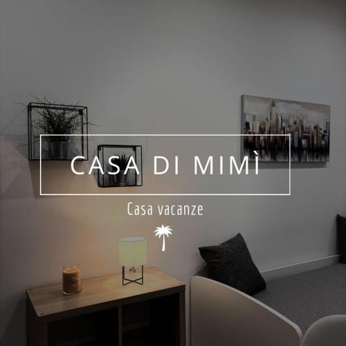 a sign that reads casa dm minimum on a room with a table at Casa di Mimì in Gela