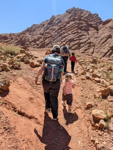 a group of people walking down a dirt trail at Auberge la belle vue dades in Akhendachou nʼAït Ouffi