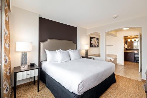 a hotel room with a bed and a living room at The Grandview at Las Vegas in Las Vegas