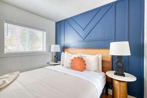 a bedroom with a bed with a blue accent wall at Stay Portland - Brooklyn 1 Bedroom Stylish Suite in Portland