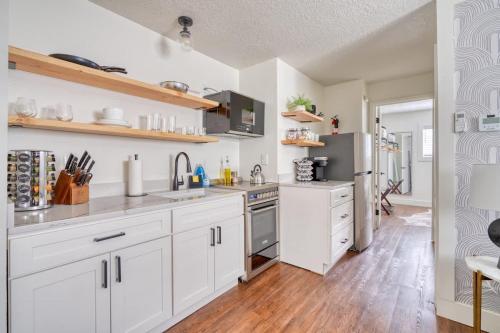 a kitchen with white cabinets and stainless steel appliances at Stay Portland - Beautiful Brooklyn 1 Bed Apt in Portland