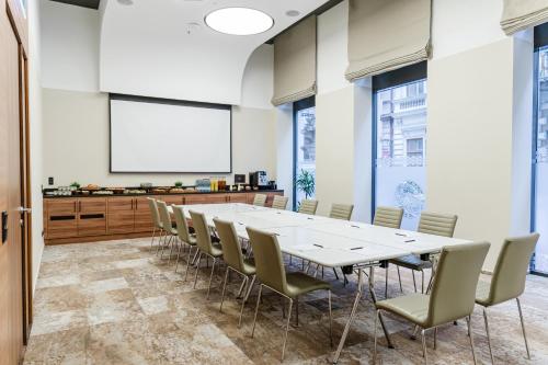 a conference room with a large white table and chairs at Hotel Moments Budapest by Continental Group in Budapest