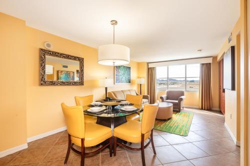 a dining room and living room with a table and chairs at The Grandview at Las Vegas in Las Vegas