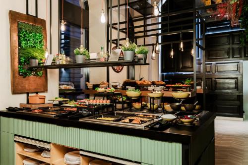 a buffet line with many different types of food at Hotel Moments Budapest by Continental Group in Budapest