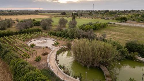 an aerial view of a farm with a river at Masseria Messapia Wine Resort & Spa Salento in Mesagne