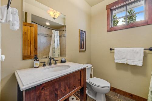 a bathroom with a sink and a toilet at Lady Luck by the Beach - Downtown Greystone unit with air conditioning in McCall