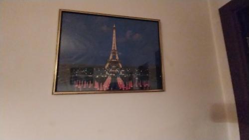 a picture of the eiffel tower on a wall at Mansión de la Bolivia in La Paz