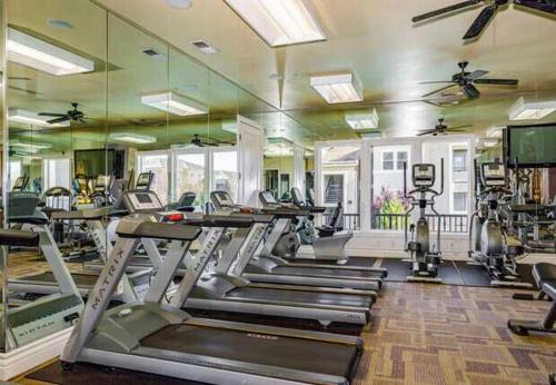 a gym with treadmills and elliptical machines at New Stylish 1BR Apt with Heated Pool Gym & Yoga Studio in Reno
