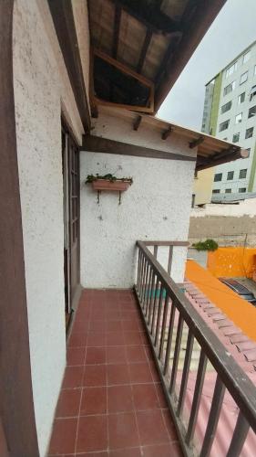a balcony of a building with a table on the wall at Mansión de la Bolivia in La Paz