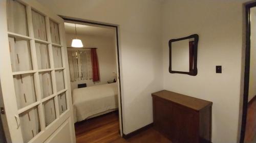 a room with a door and a mirror and a bedroom at Mansión de la Bolivia in La Paz