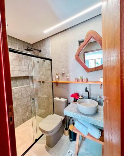 a bathroom with a toilet and a sink and a shower at Patacho Brisa Mar - Triplex na Rota Ecológica dos Milagres in Pôrto de Pedras