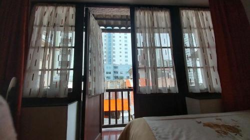 a bedroom with a window with a view of a building at Mansión de la Bolivia in La Paz