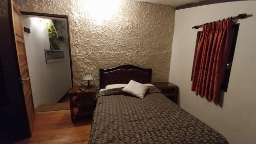 a bedroom with a bed and a red curtain at Mansión de la Bolivia in La Paz