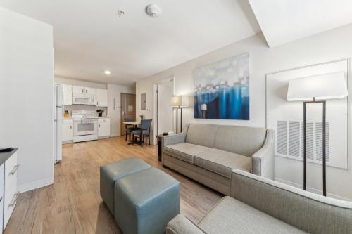 a living room with a couch and a table at Properties By Preston I Spacious 1 Bed 1 Bth in San Antonio