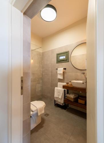 a bathroom with a sink and a mirror at Latoma Mediterranean House in Álika