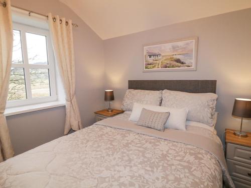 a bedroom with a bed and a window at Ballard Cottage Annexe in Newry