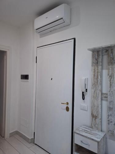 a white door in a white room with a ceiling at Casa Carlo La Spezia in La Spezia