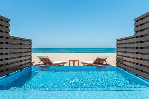 a view of the beach from the pool at the beach house at Krystal Grand Los Cabos - All Inclusive in San José del Cabo