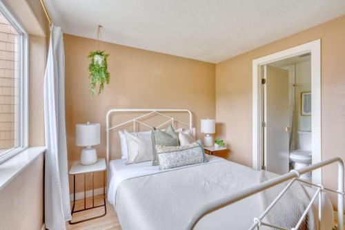 a bedroom with a white bed and a window at Stay Portland - Adorable Bright 1 Bed Near OHSU in Portland