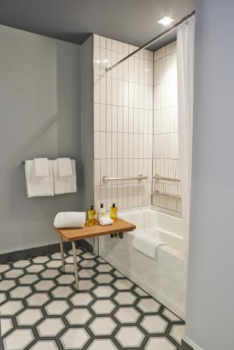 a bathroom with a table and a bath tub at Thompson Dallas, by Hyatt in Dallas